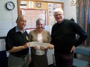 Geoff Phipps and Mike Sharpe present cheques to Frances Colliver of Headway